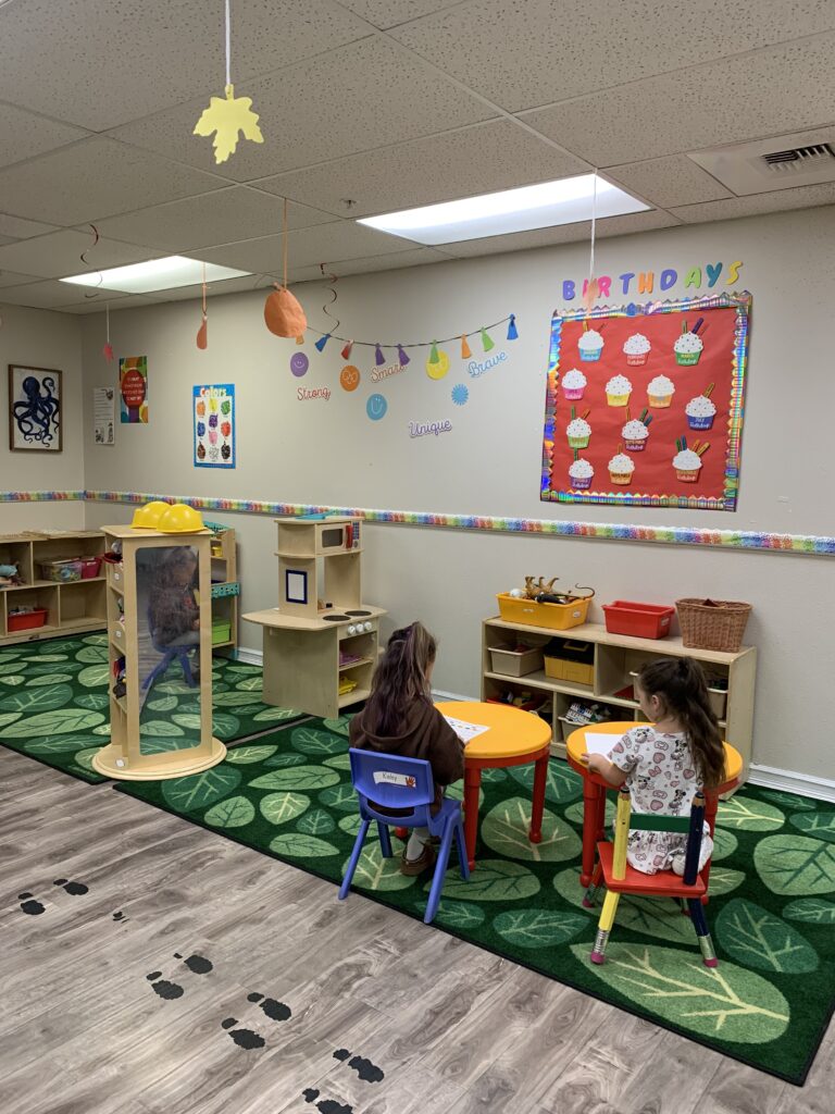 Art and reading corner with jungle mural TK students working at their tables in the transitional kindergarten classroom at Ascend To The Heights in Spokane